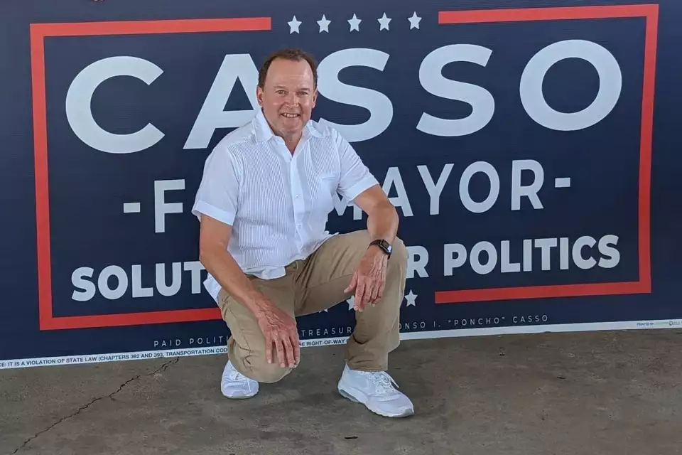Poncho Casso beside his Casso for Mayor campaign sign